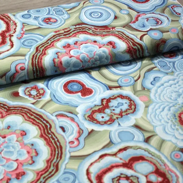 Algodón patchwork Kaffe Fassett Agate Turquoise con círculos y flores de 110cm - Vista del lomo enrollado